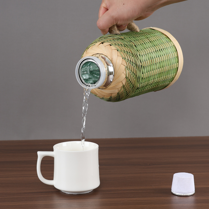 Pouring from the bamboo flask into a cup